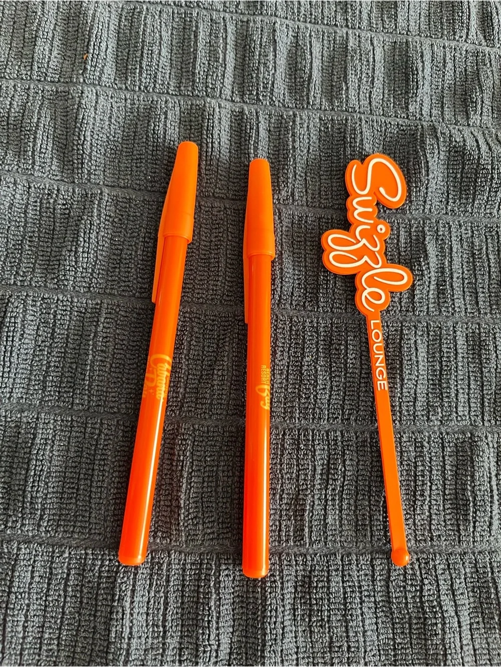 One Orange Drink Swizzle stick drink Stirrers and two Cabana Bay pens